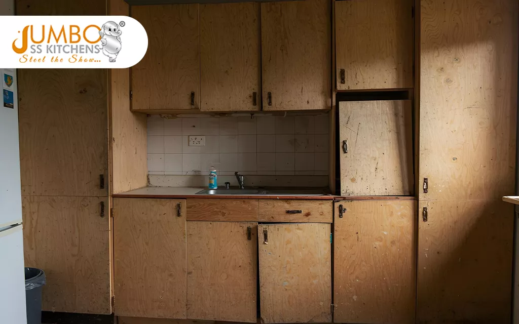 Damaged Plywood Kitchen Cabinets in Coastal Vizag Home, Showing Warping and Peeling due to Humidity